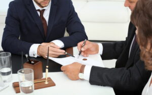 Lawyer and client signing legal documents