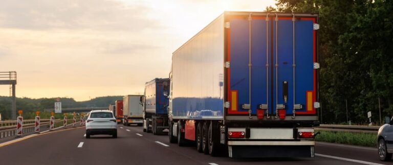 A truck driving on a highway alongside other cars, illustrating a sideswipe accident scenario.